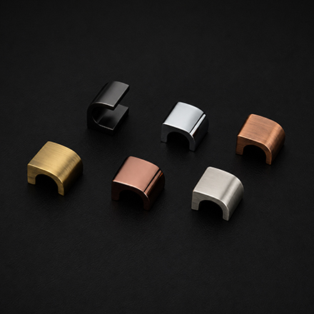 Dark textured cylindrical cabinet knob with polished brass base