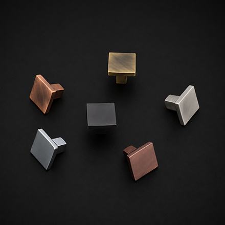 Dark textured T-bar cabinet knob with central polished brass stem