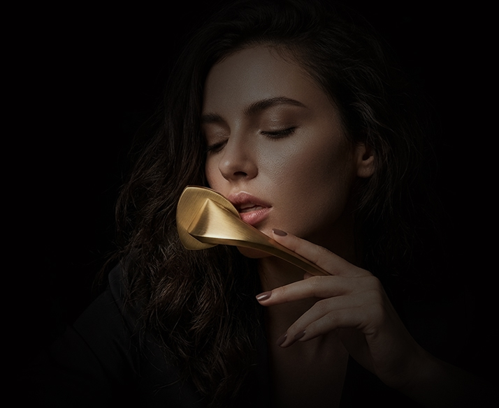 Collection of modern brass and metal cabinet handles on wooden furniture