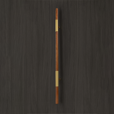 Dark textured cylindrical pull handle with brass end caps