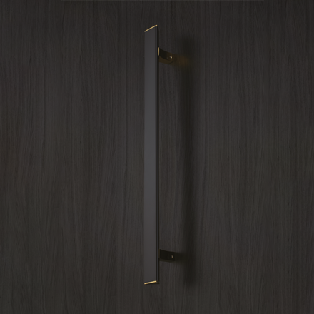 Dark textured pull handle with polished brass mounting brackets