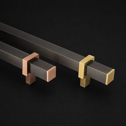 Dark textured pull handle with brass mounting brackets