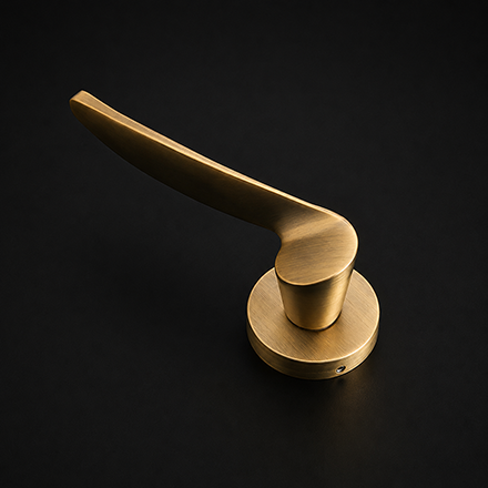 Dual-tone brass and black textured lever door handle on a round rose