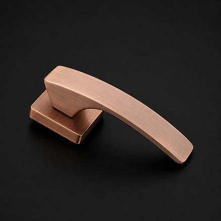 Curved brass and black textured lever door handle on a round rose