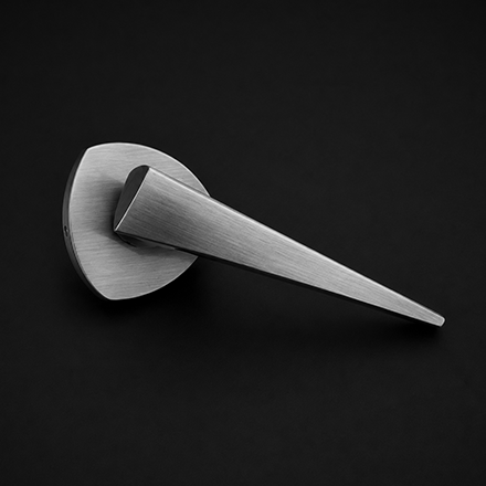 Dual-tone brass and black textured lever door handle on a round rose