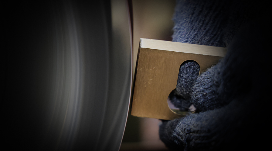 Hand polishing and buffing process for luxury brass door handles at Atcraft